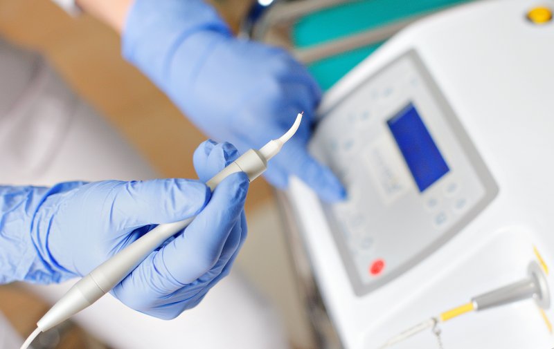 Dentist holding a dental laser